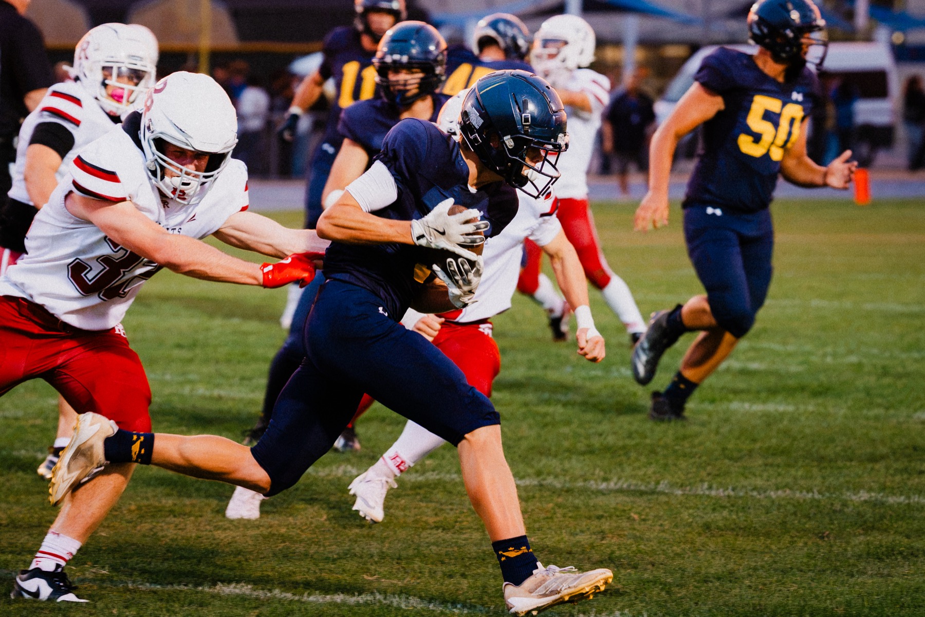 An Arroyo Grande running back fights through a tackle attempt against Paso Robles