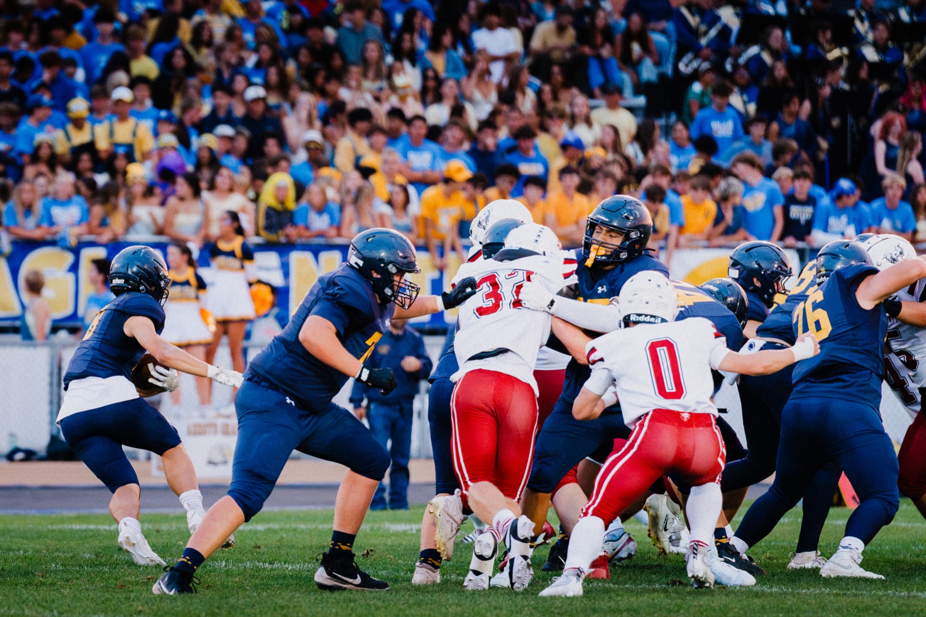 Arroyo Grande and Paso Robles players collide in a scrum near the line of scrimmage