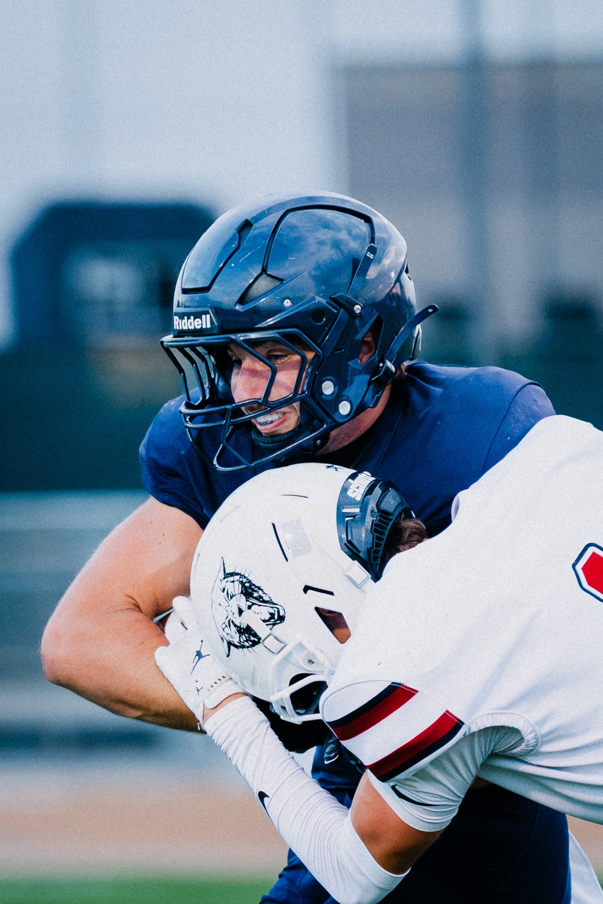An Arroyo Grande and a Paso Robles player face off helmet to helmet after a play