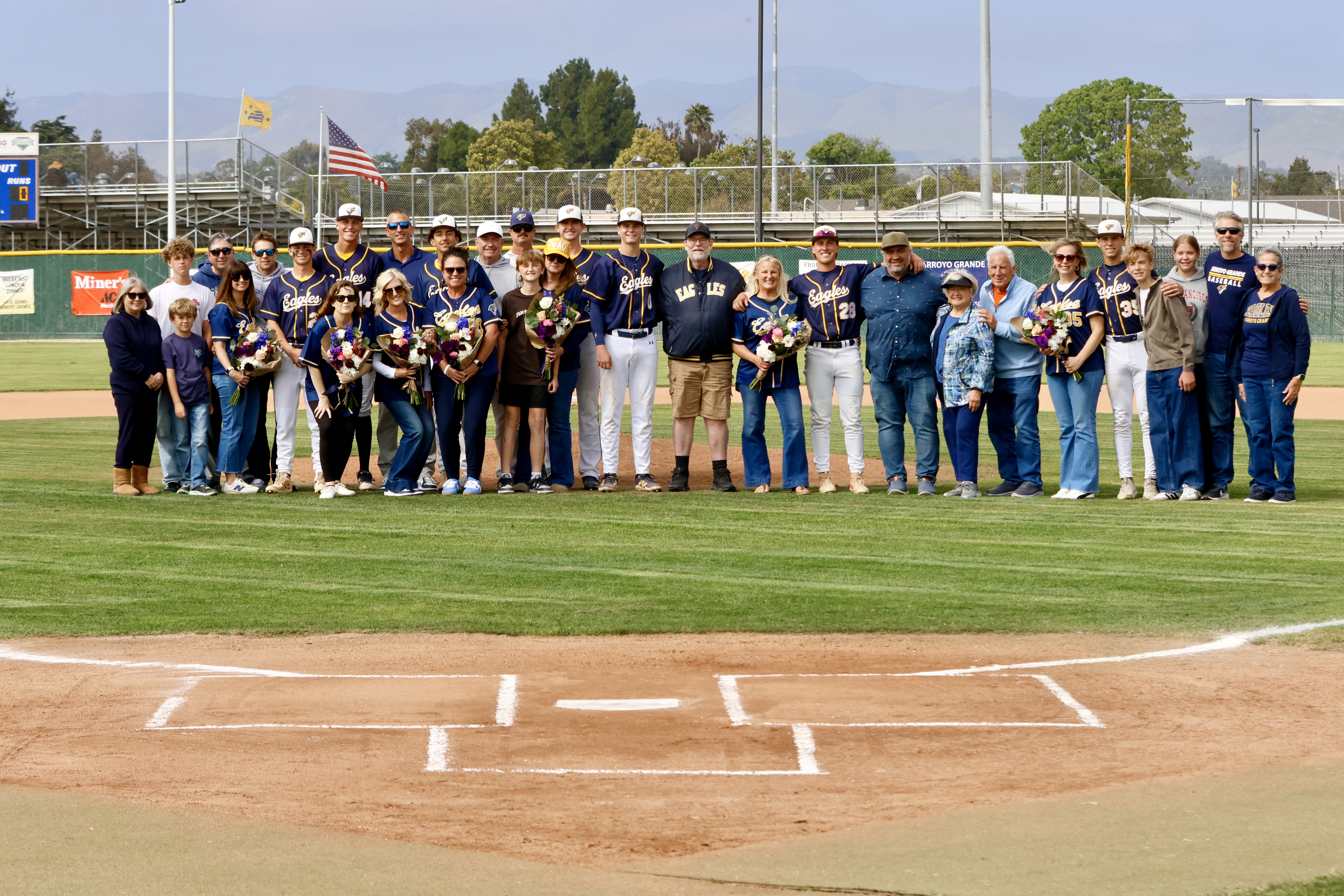 Arroyo Grande Eagles seniors and families at home plate — Senior Night 2026