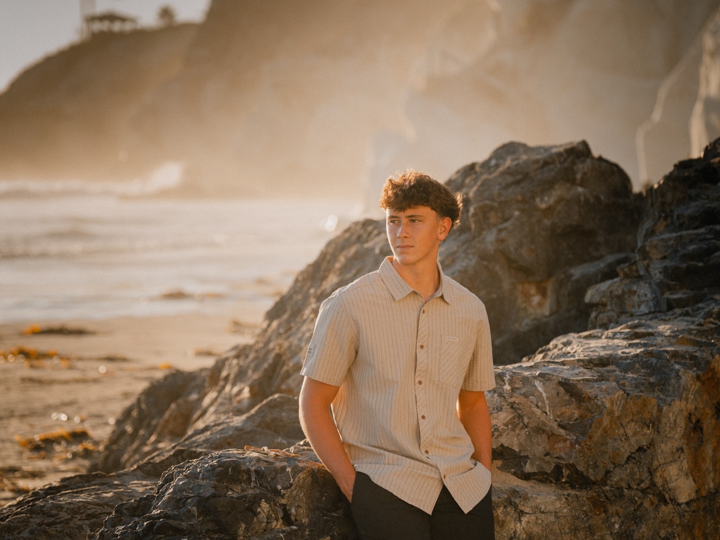 Senior portrait standing on coastal rocks, Central Coast California