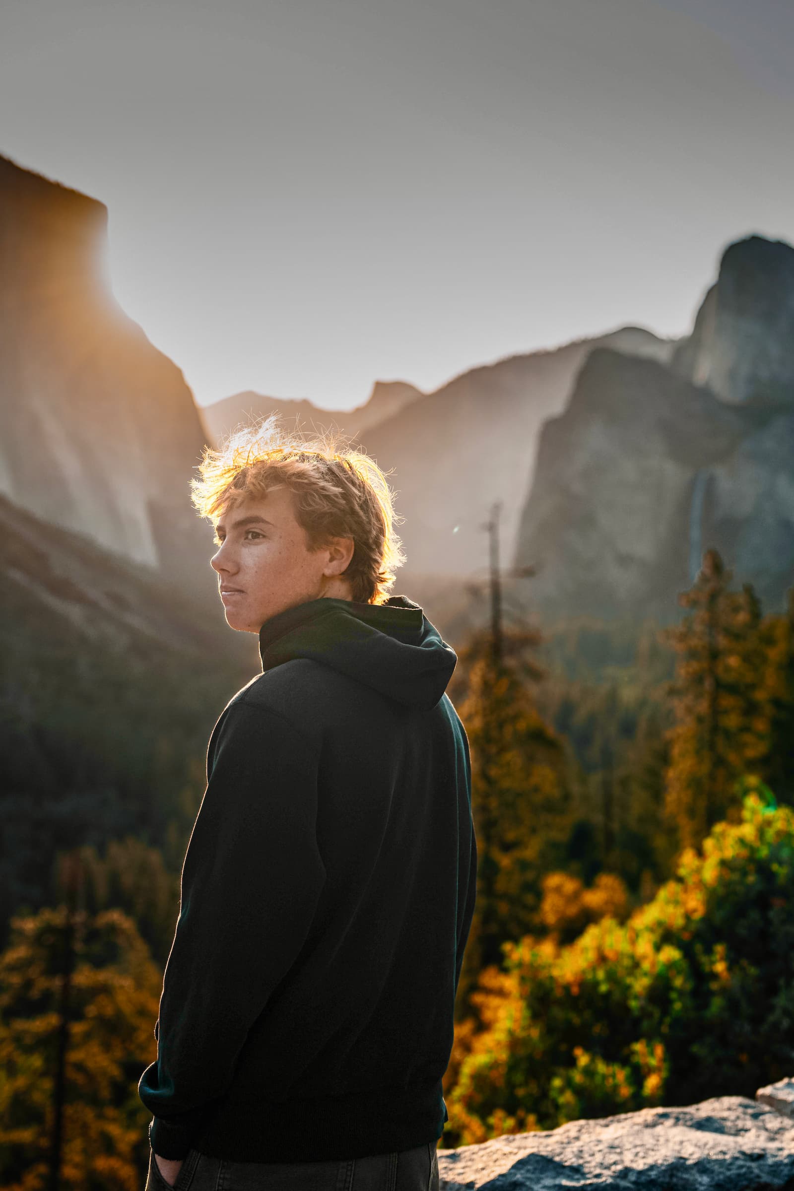 Senior portrait at Yosemite with Half Dome at golden hour